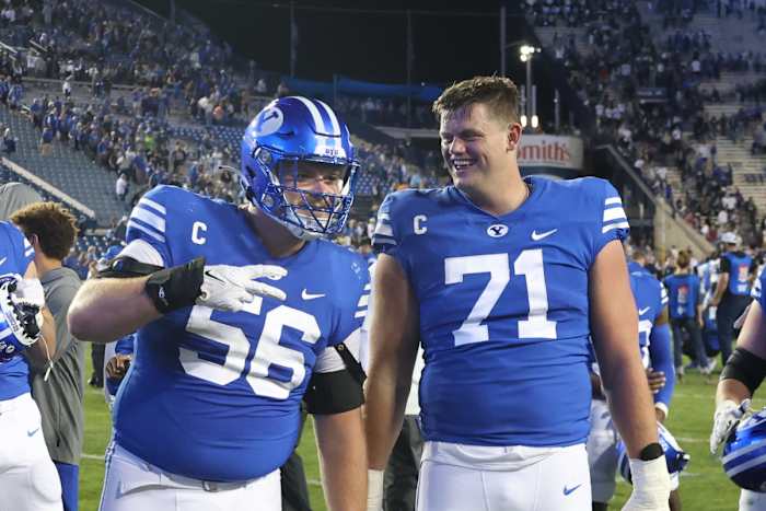 Sep 29, 2022; Provo, Utah, USA; Brigham Young Cougars offensive lineman Clark Barrington (56) and offensive lineman Blake Freeland (71) celebrate the victory against the Utah State Aggies at LaVell Edwards Stadium. Mandatory Credit: Rob Gray-USA TODAY Sports
